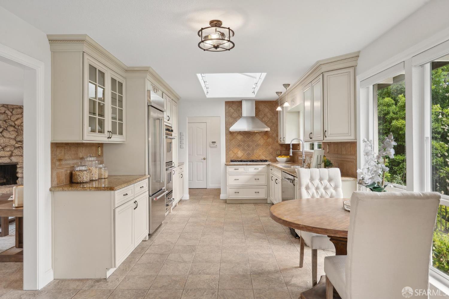 375 Montecillo Drive Walnut Creek, CA 94595 - Photo 19 of 79 a open kitchen with stainless steel appliances kitchen island a stove a table and chairs in it