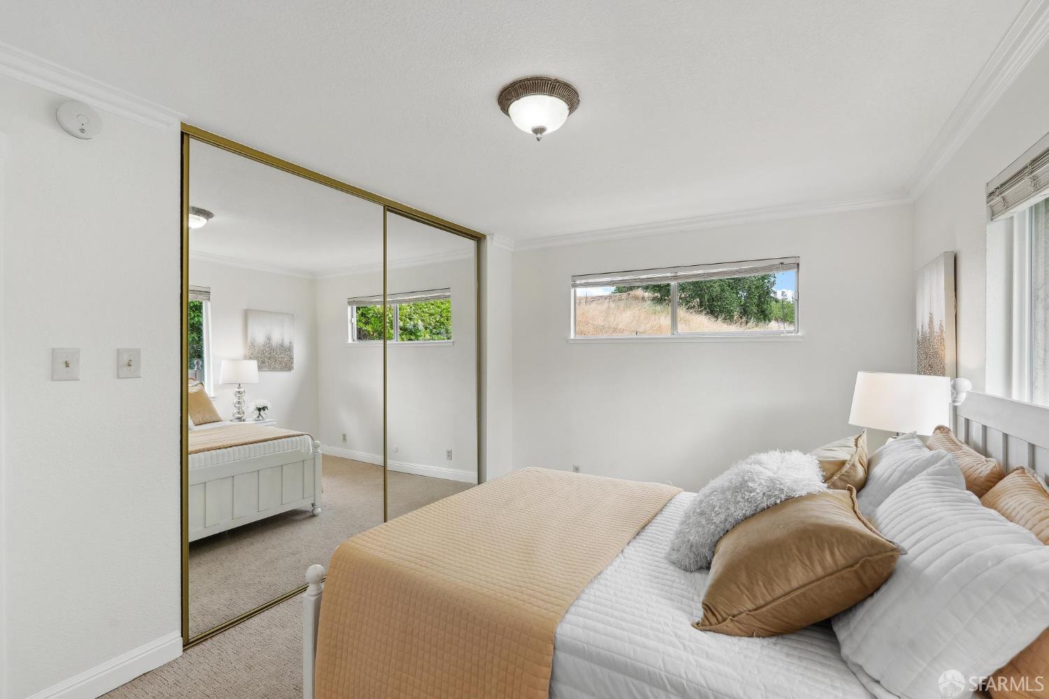 375 Montecillo Drive Walnut Creek, CA 94595 - Photo 35 of 79 a bedroom with a bed and a chandelier