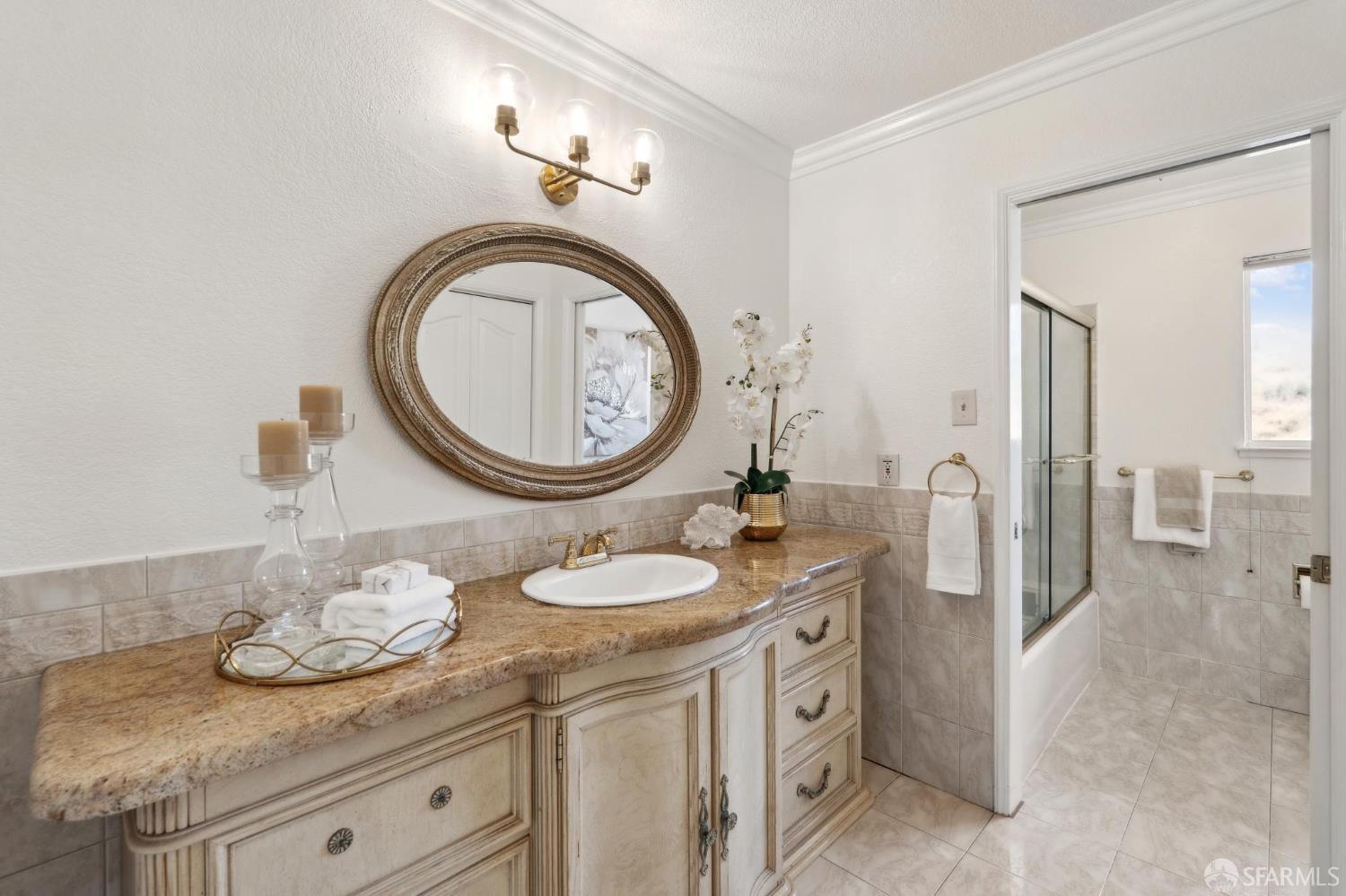 375 Montecillo Drive Walnut Creek, CA 94595 - Photo 40 of 79 a bathroom with a granite countertop sink and a mirror