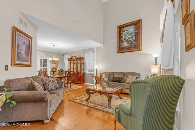 a view of a dining room with furniture and chandelier