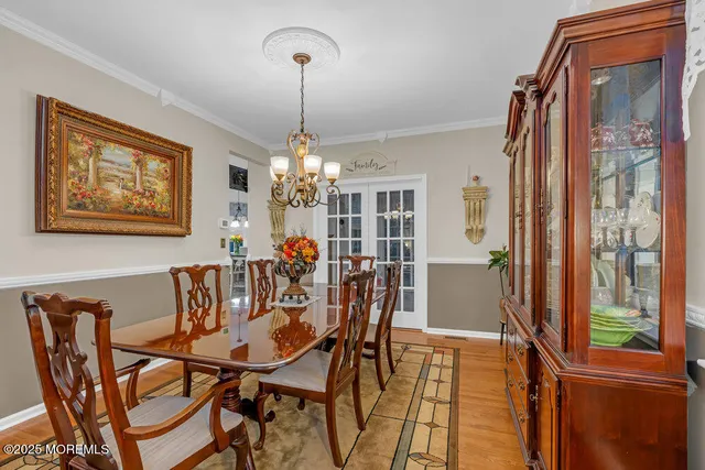 a view of a dining room with furniture and chandelier