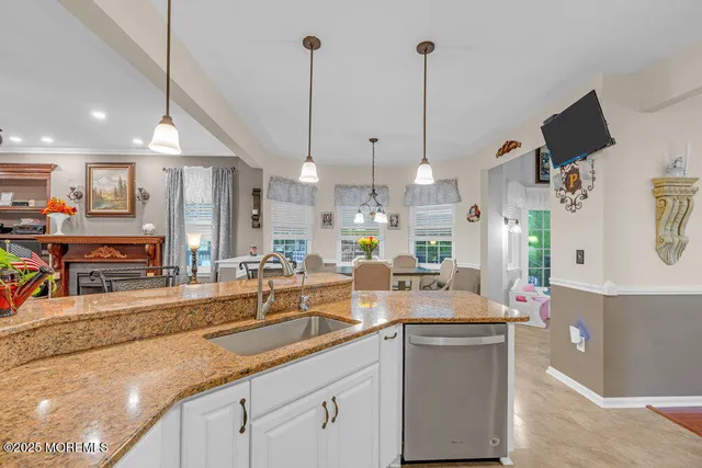 a dining room with furniture a chandelier and a rug