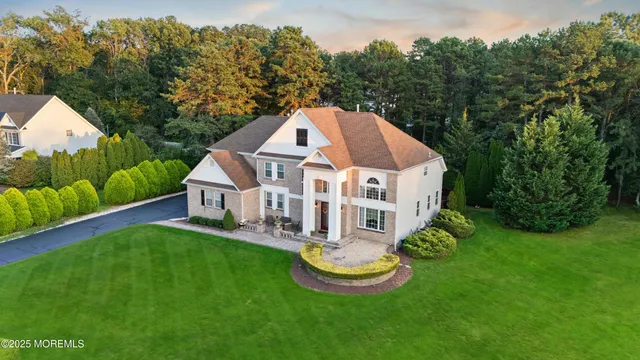 a aerial view of a house with swimming pool and yard with green space