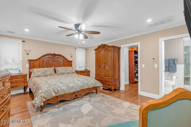 a view of a hallway with wooden floor staircase and a living room