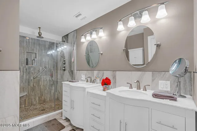 a kitchen with stainless steel appliances granite countertop a sink a stove and a wooden floor