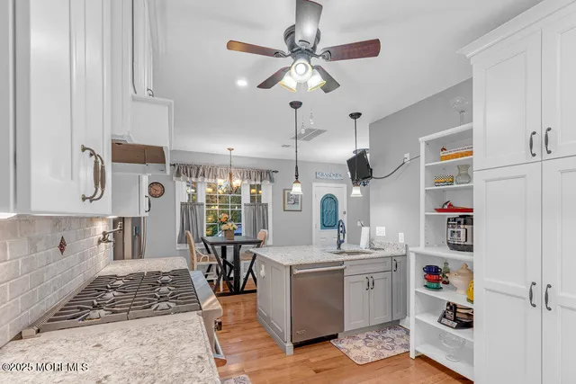 a kitchen with refrigerator and cabinets