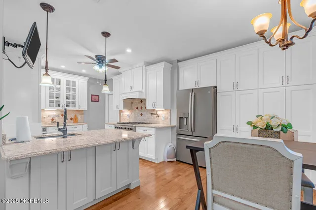 a living room with furniture a large window and a flat screen tv