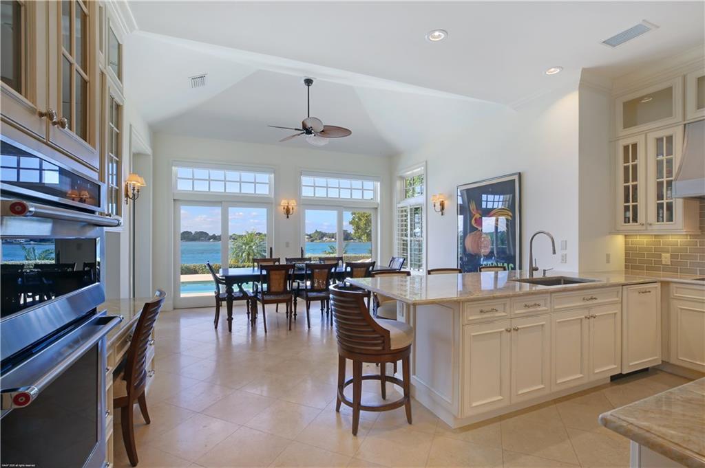 37 West High Point Road Stuart, FL 34996 - Photo 16 of 35 a view of a dining room with furniture window and wooden floor