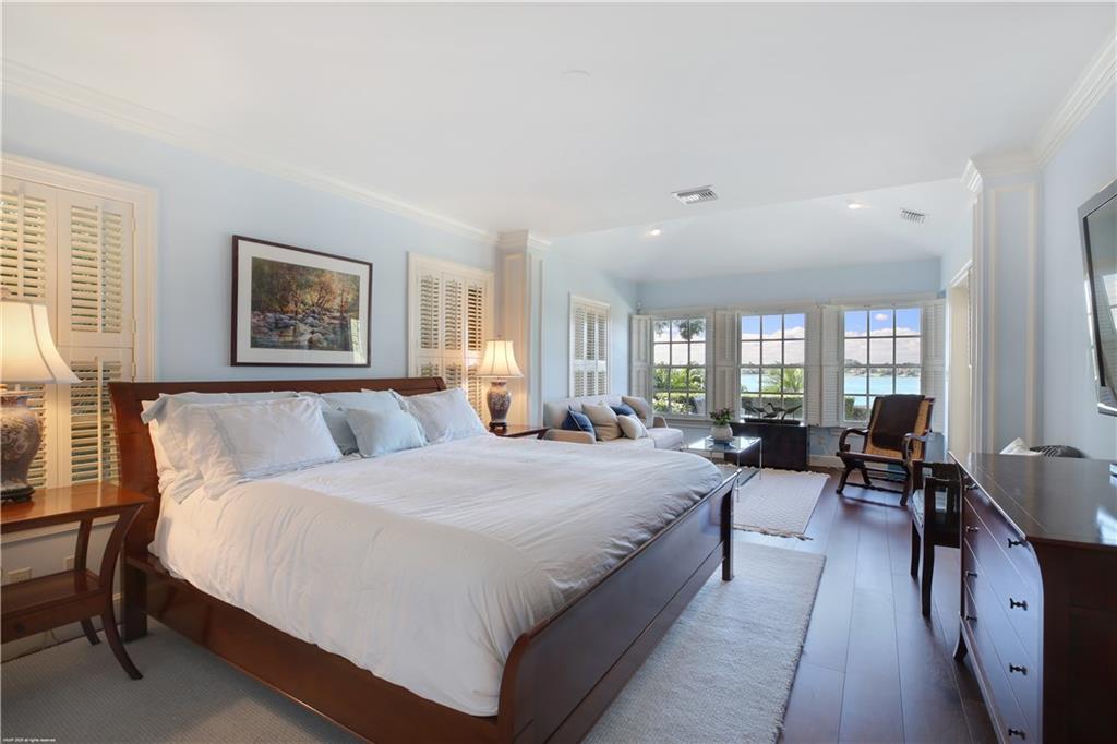 37 West High Point Road Stuart, FL 34996 - Photo 20 of 35 a spacious bedroom with bed and a large window