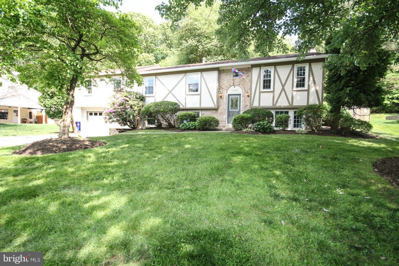 14305 Piccadilly Road Silver Spring, MD 20906 - Photo 2 of 30 a view of a yard in front of a house with plants and large trees
