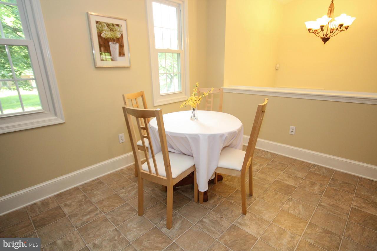 14305 Piccadilly Road Silver Spring, MD 20906 - Photo 12 of 30 a view of a dining room with furniture and a window