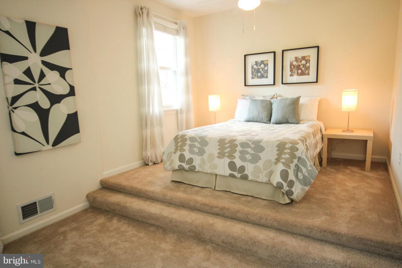 14305 Piccadilly Road Silver Spring, MD 20906 - Photo 13 of 30 a bedroom with a bed and a window