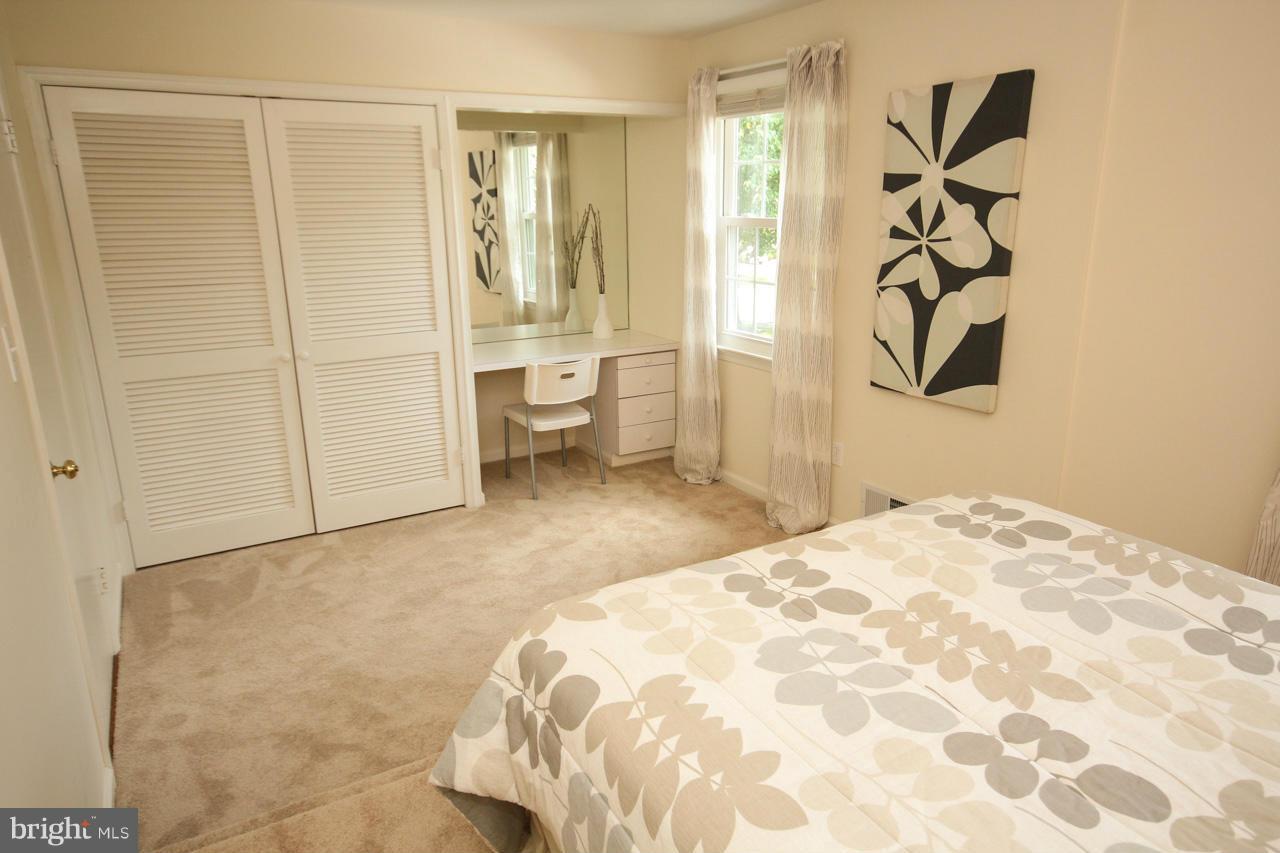 14305 Piccadilly Road Silver Spring, MD 20906 - Photo 14 of 30 a bedroom with a bed and a window