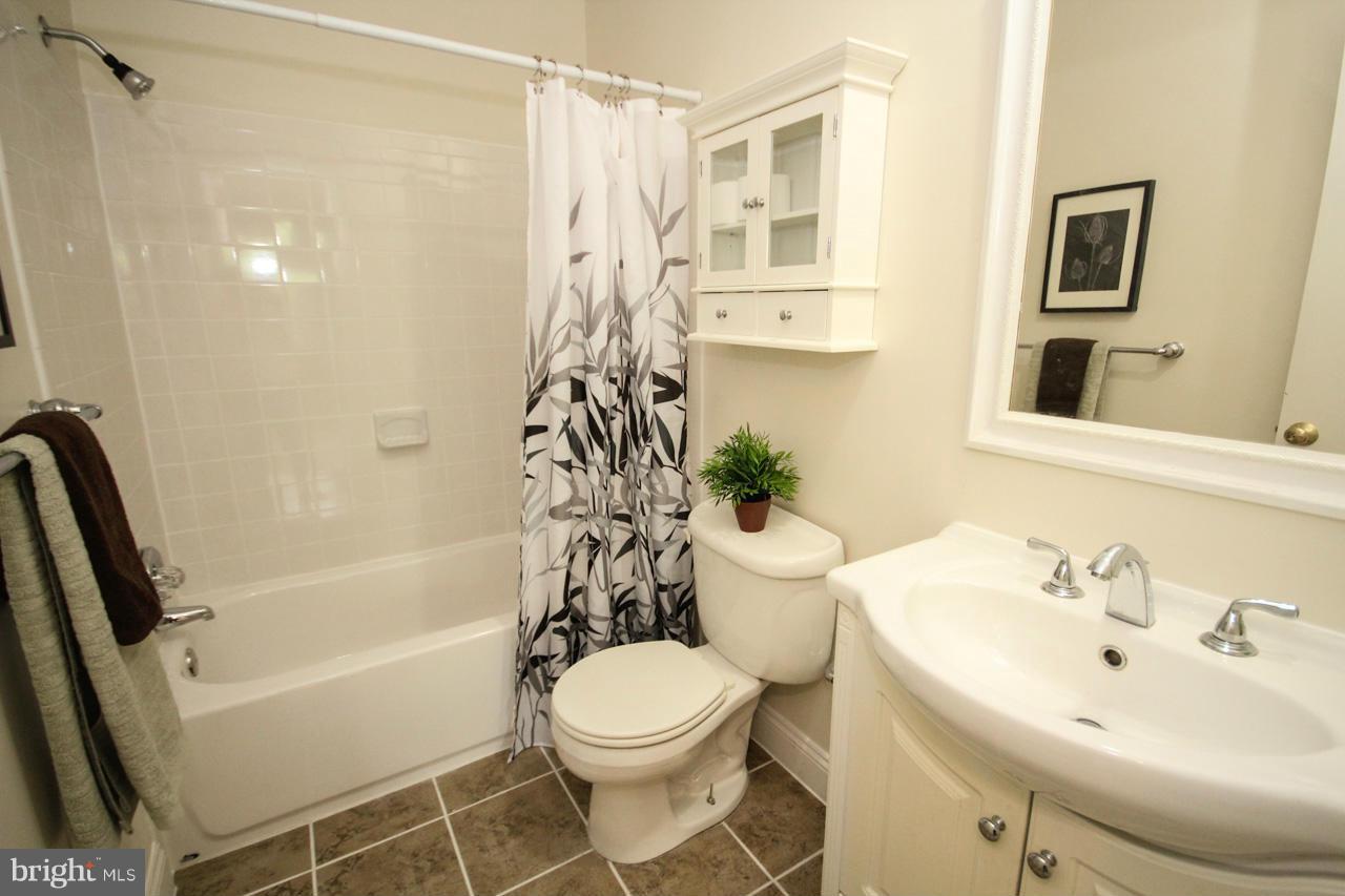 14305 Piccadilly Road Silver Spring, MD 20906 - Photo 15 of 30 a bathroom with a sink toilet and shower