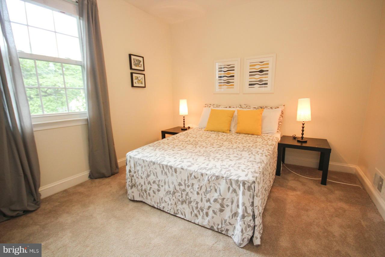 14305 Piccadilly Road Silver Spring, MD 20906 - Photo 16 of 30 a bedroom with a bed and a window