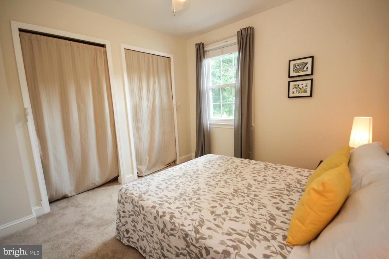 14305 Piccadilly Road Silver Spring, MD 20906 - Photo 17 of 30 a bedroom with a bed and a window