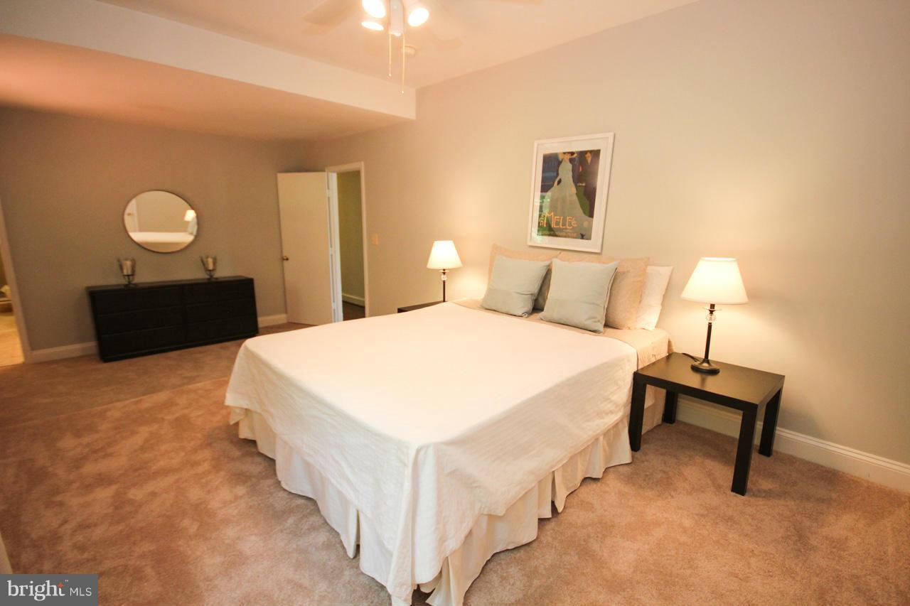 14305 Piccadilly Road Silver Spring, MD 20906 - Photo 20 of 30 a bedroom with a bed and a lamp