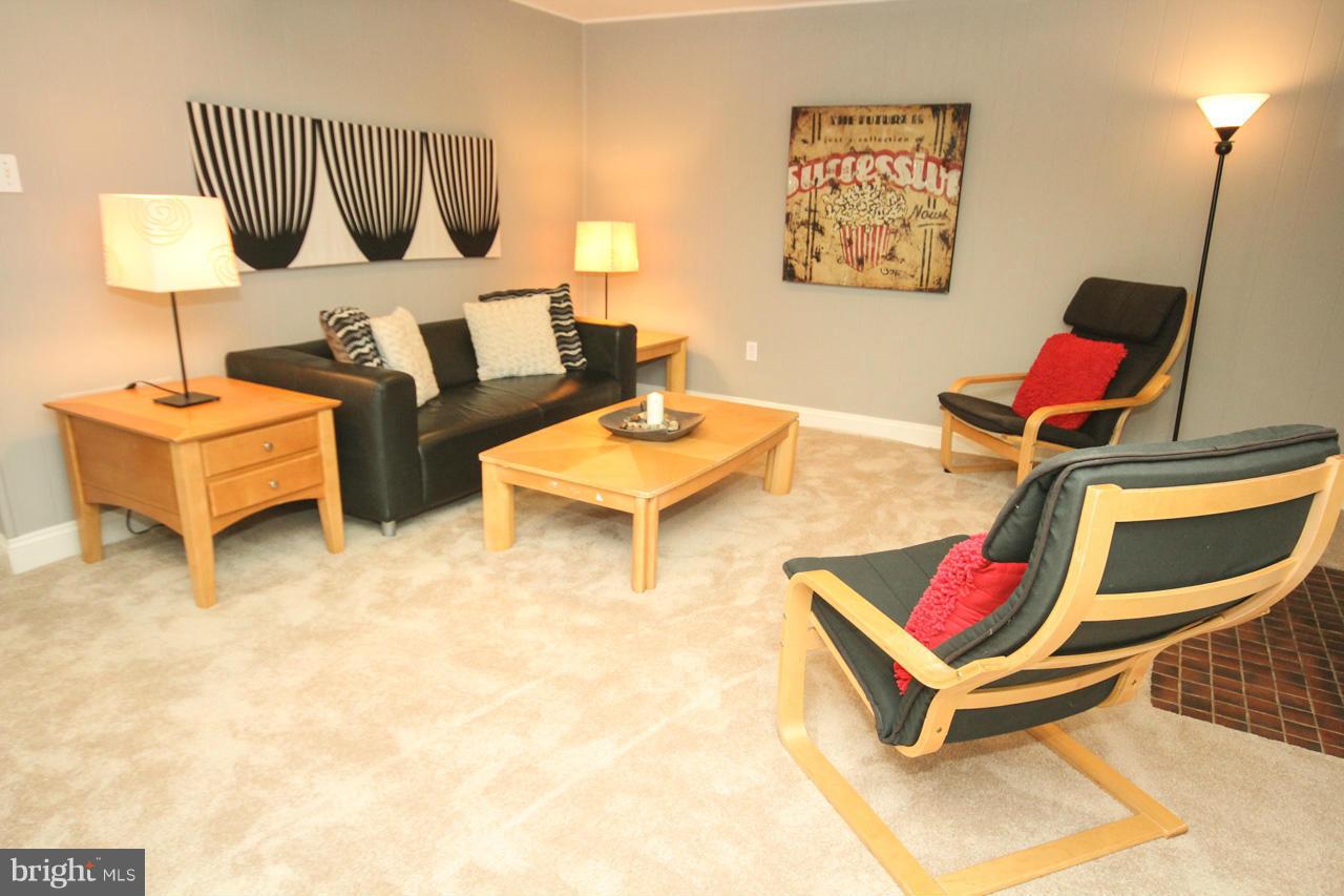 14305 Piccadilly Road Silver Spring, MD 20906 - Photo 23 of 30 a living room with furniture and a table