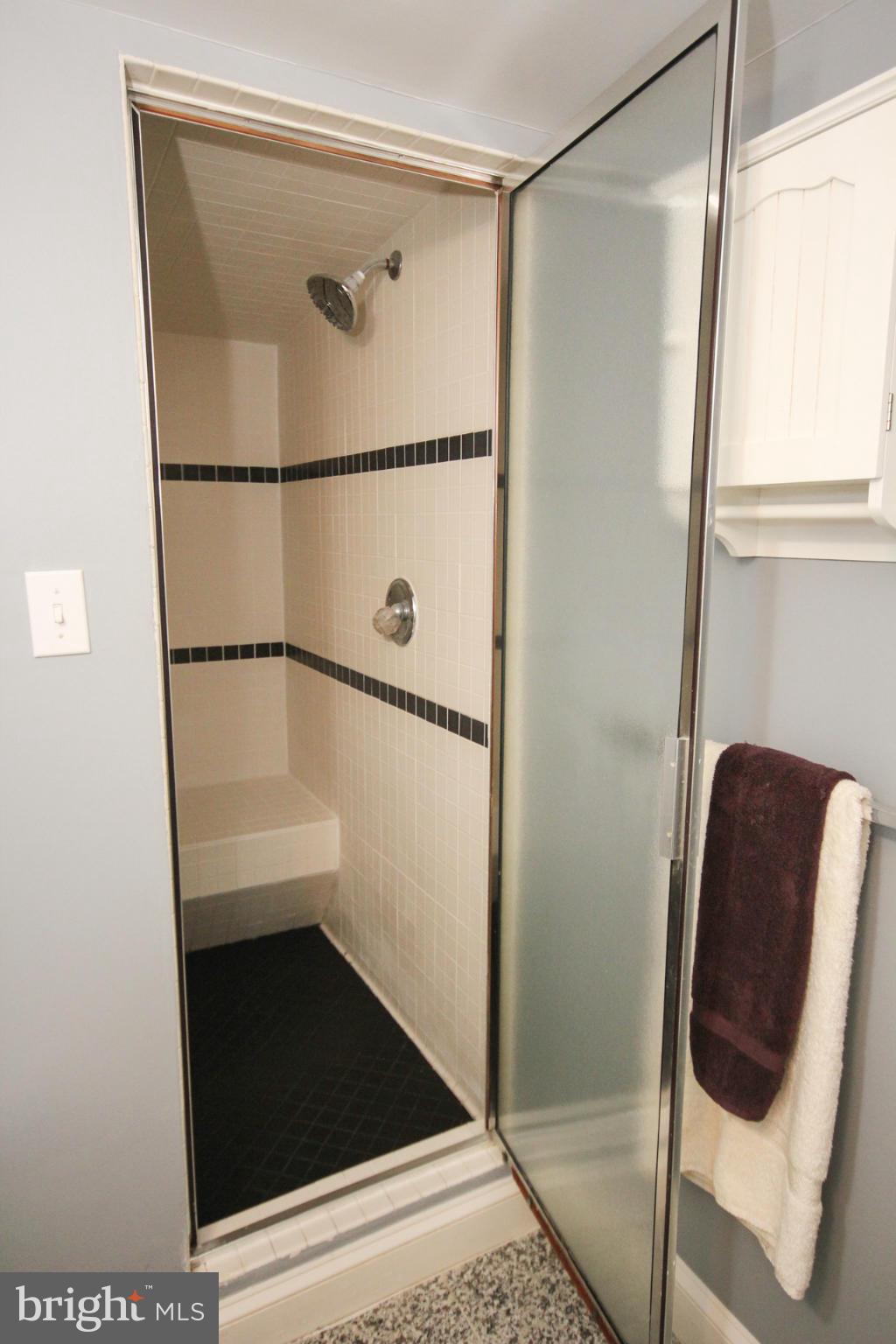 14305 Piccadilly Road Silver Spring, MD 20906 - Photo 27 of 30 a bathroom with a glass shower door