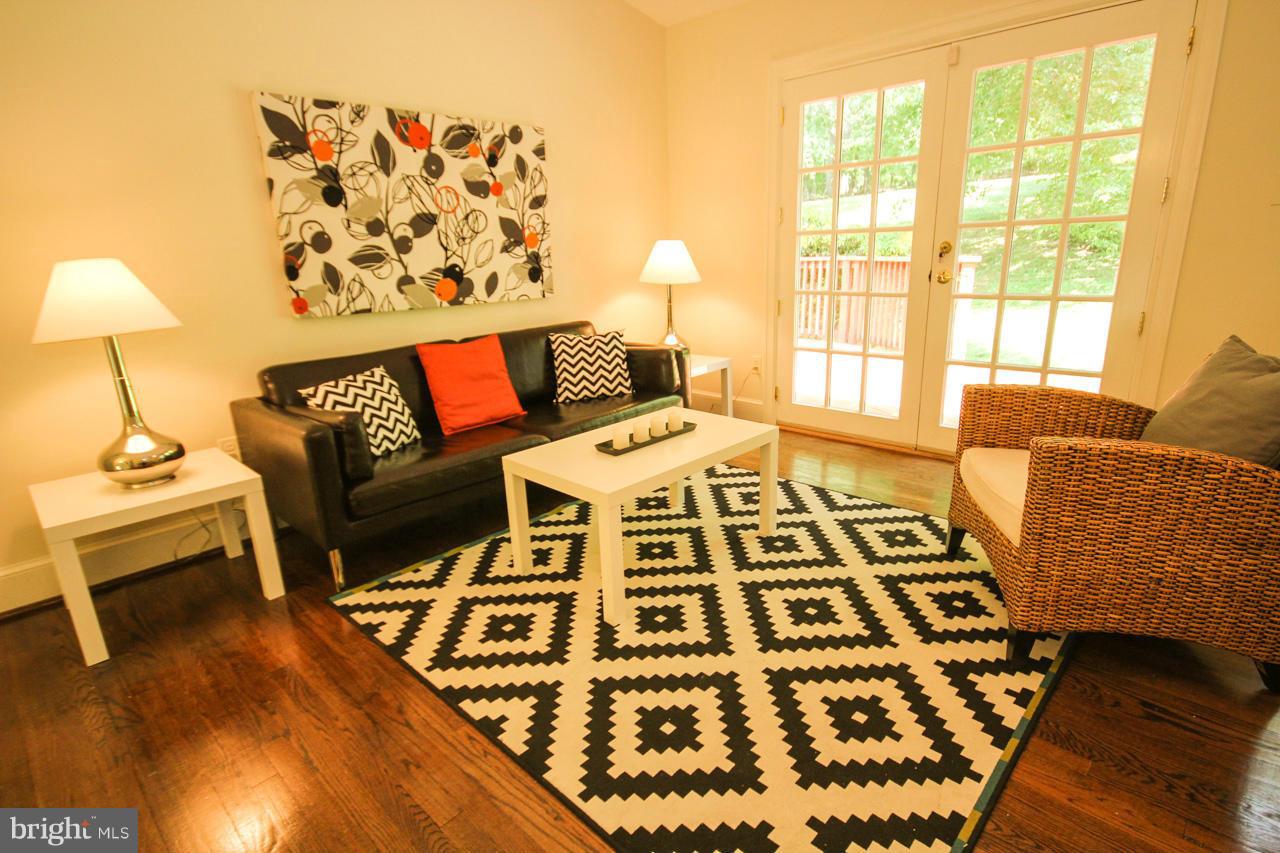 14305 Piccadilly Road Silver Spring, MD 20906 - Photo 6 of 30 a living room with a couch and a table with wooden floor