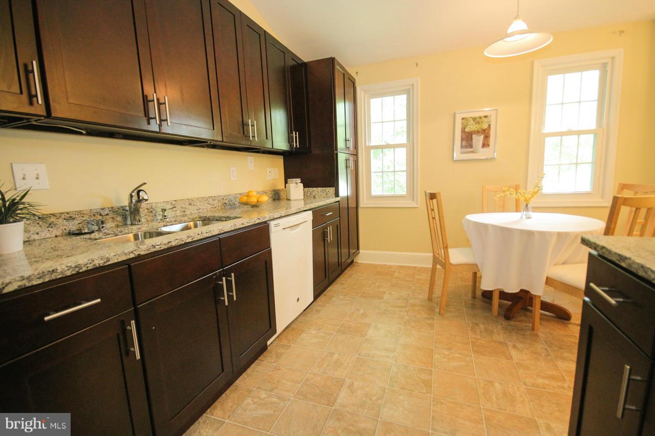 14305 Piccadilly Road Silver Spring, MD 20906 - Photo 9 of 30 a kitchen with a sink stove and cabinets