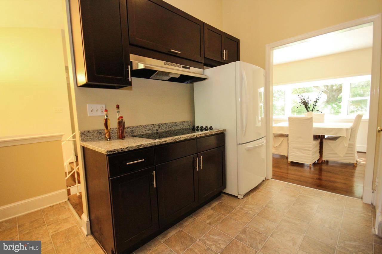 14305 Piccadilly Road Silver Spring, MD 20906 - Photo 10 of 30 a kitchen with a refrigerator and a sink