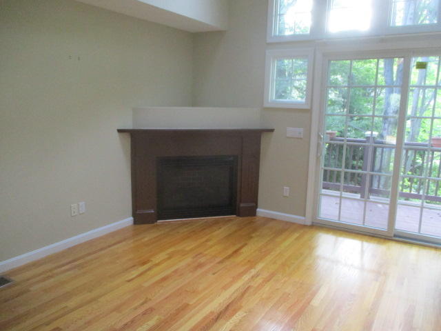 15 Gold Leaf Lane Mashpee, MA 02649 - Photo 3 of 14 a view of empty room with wooden floor and fireplace