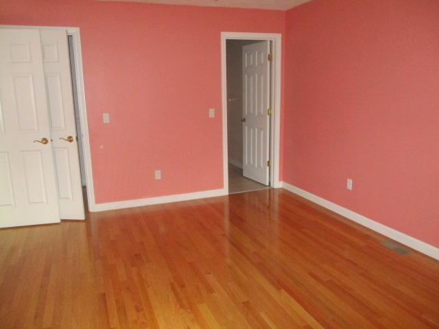 15 Gold Leaf Lane Mashpee, MA 02649 - Photo 5 of 14 a view of an empty room with wooden floor and a window