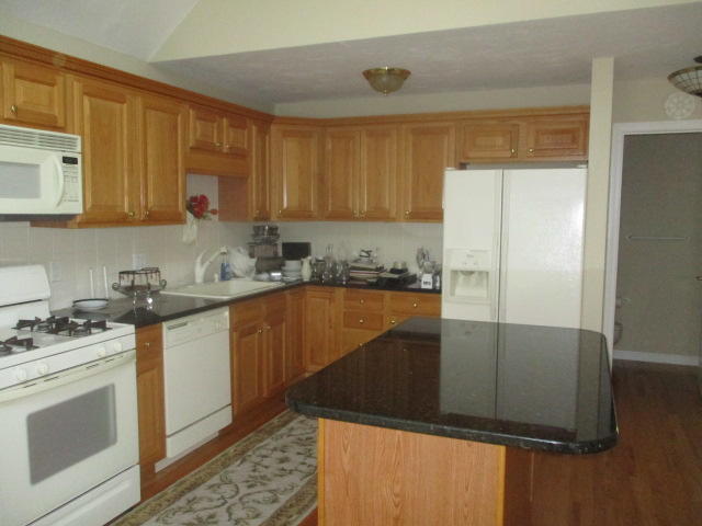 15 Gold Leaf Lane Mashpee, MA 02649 - Photo 9 of 14 a kitchen with a sink a stove and refrigerator