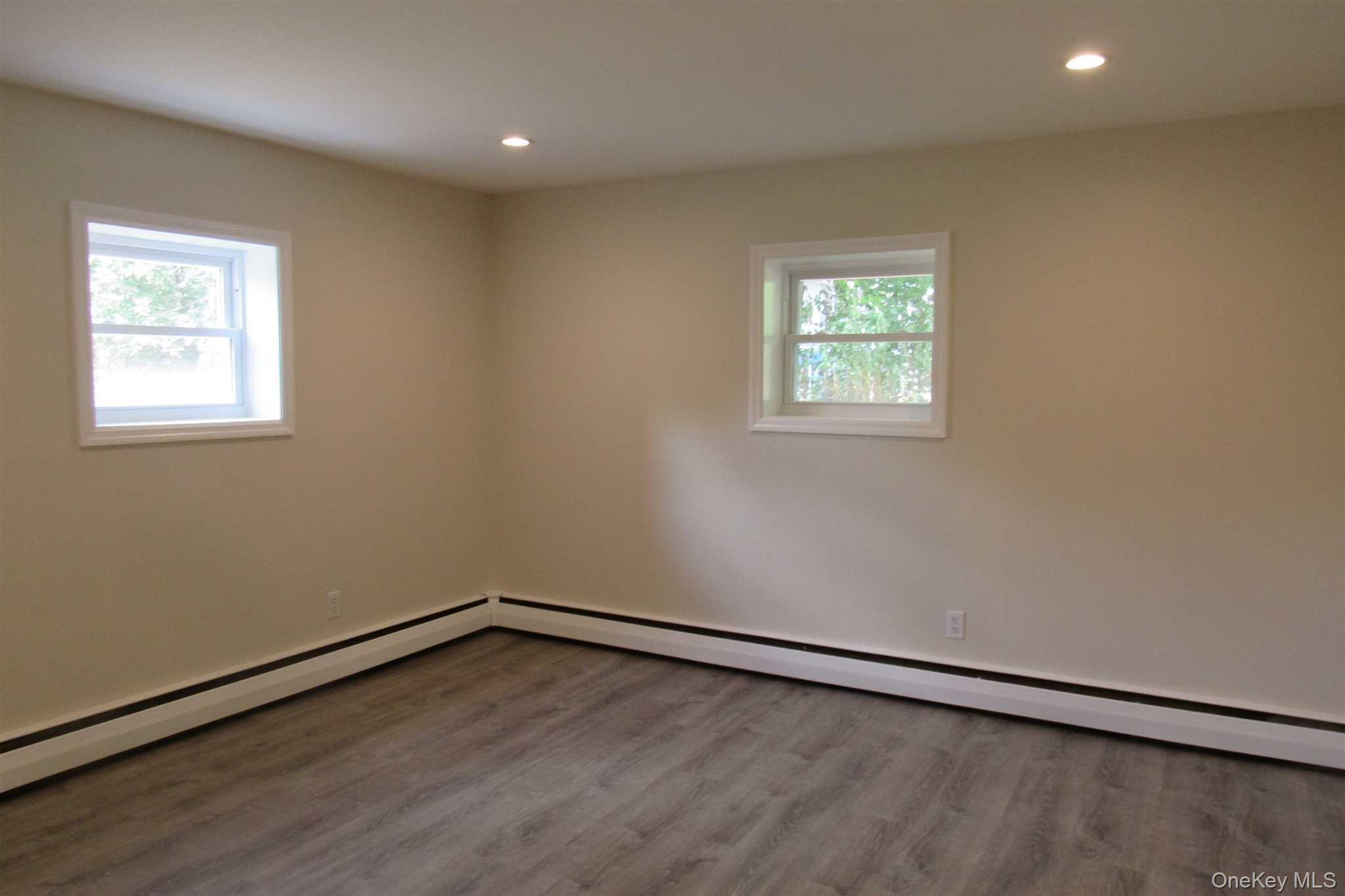 1425 Highway 82, Unit B Hopewell Junction, NY 12533 - Photo 15 of 19 an empty room with wooden floor and windows