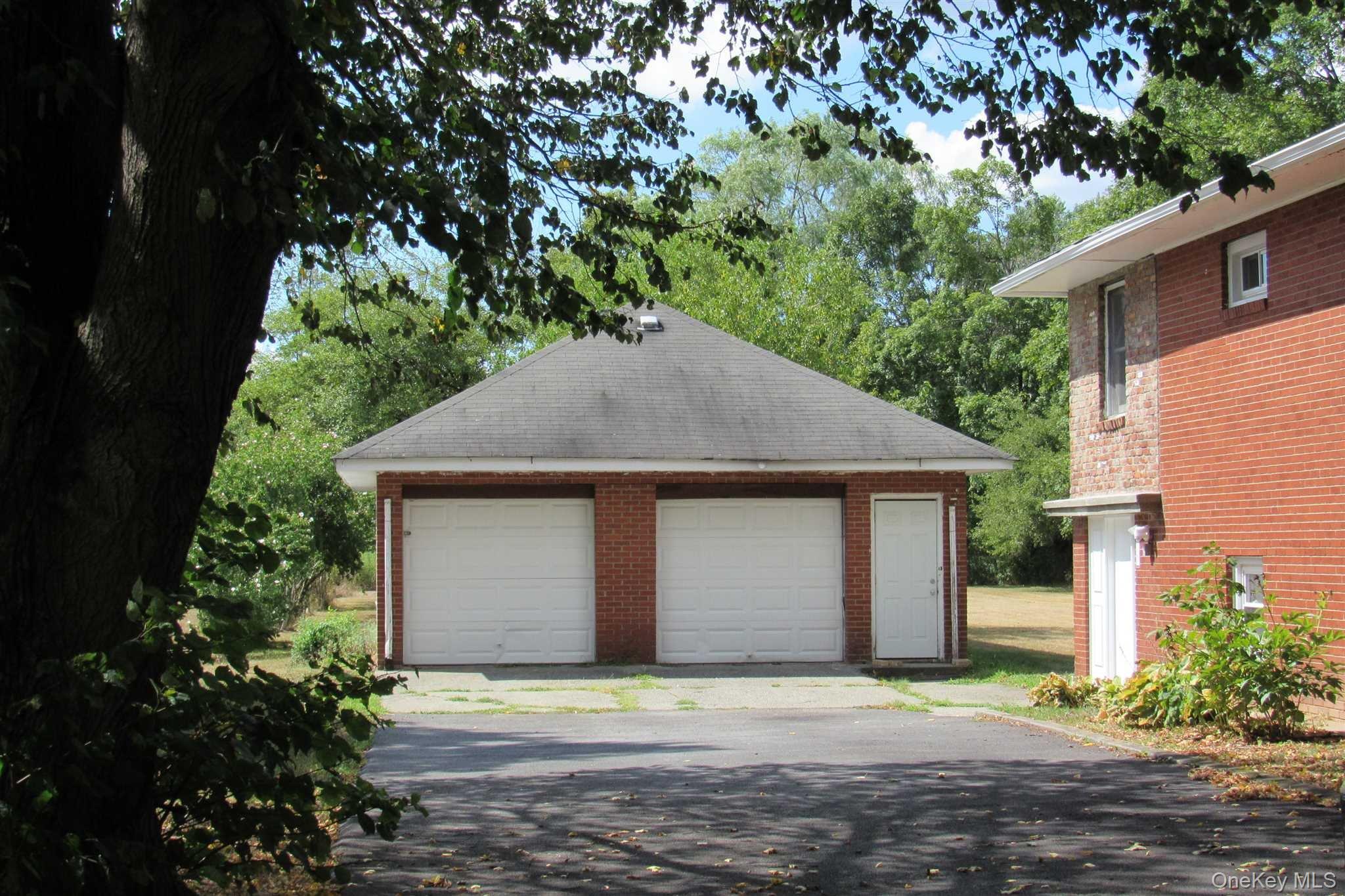 1425 Highway 82, Unit B Hopewell Junction, NY 12533 - Photo 18 of 19 a front view of a house with a yard and garage