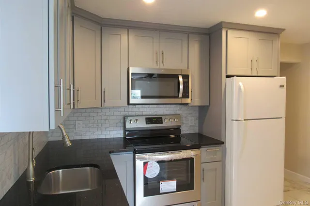a kitchen with a sink a stove and refrigerator