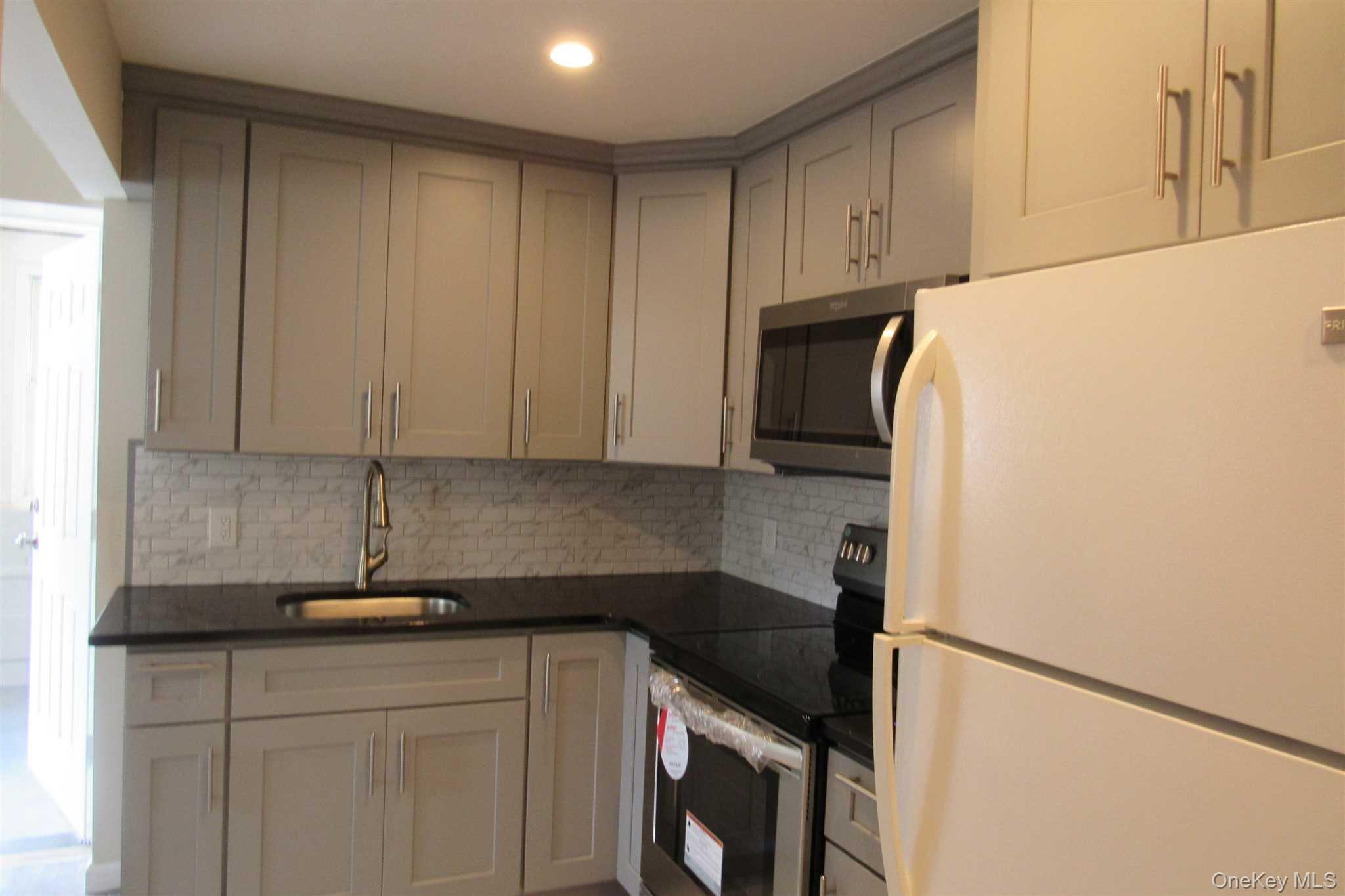 1425 Highway 82, Unit B Hopewell Junction, NY 12533 - Photo 9 of 19 a kitchen with a sink and a refrigerator