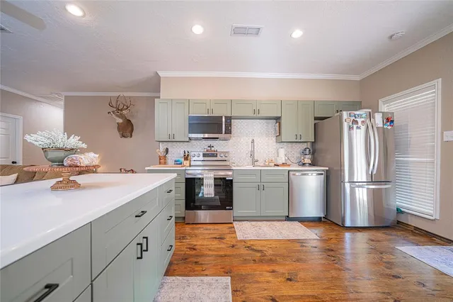 a kitchen with sink cabinets and wooden floor