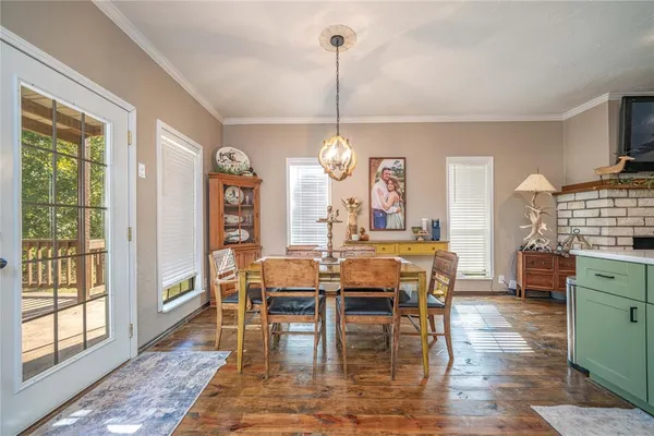 a bedroom with a bed and a flat tv screen on dresser