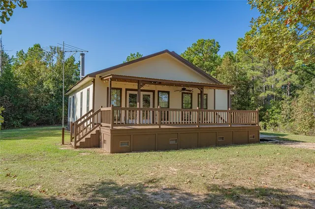 a view of a porch with furniture and wooden deck