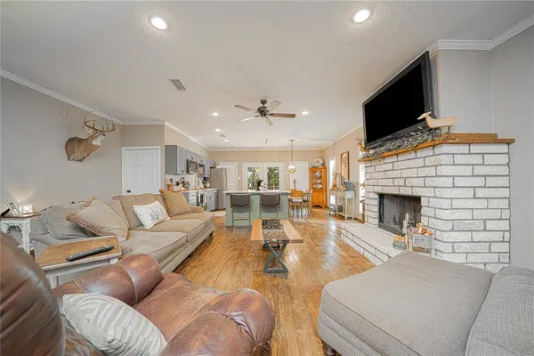 a living room with furniture a fireplace and a flat screen tv