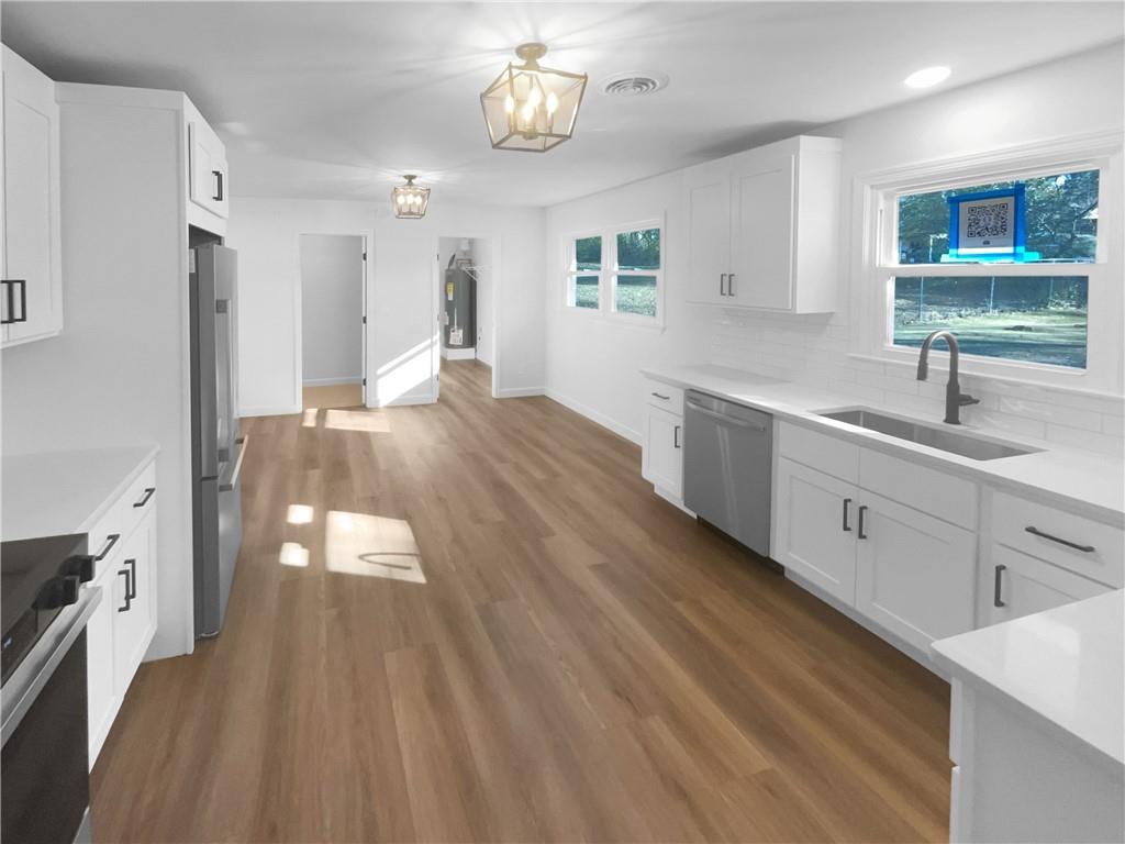 314 Jackson Street Cartersville, GA 30120 - Photo 11 of 18 a kitchen with a sink and wooden floor