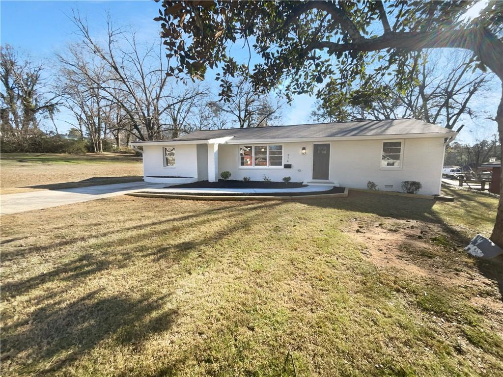 314 Jackson Street Cartersville, GA 30120 - Photo 16 of 18 a view of a house with a yard covered with snow in front of it