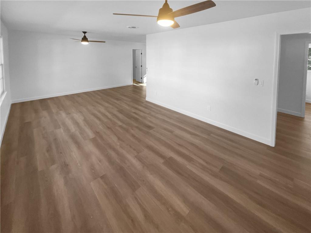 314 Jackson Street Cartersville, GA 30120 - Photo 3 of 18 an empty room with wooden floor and windows