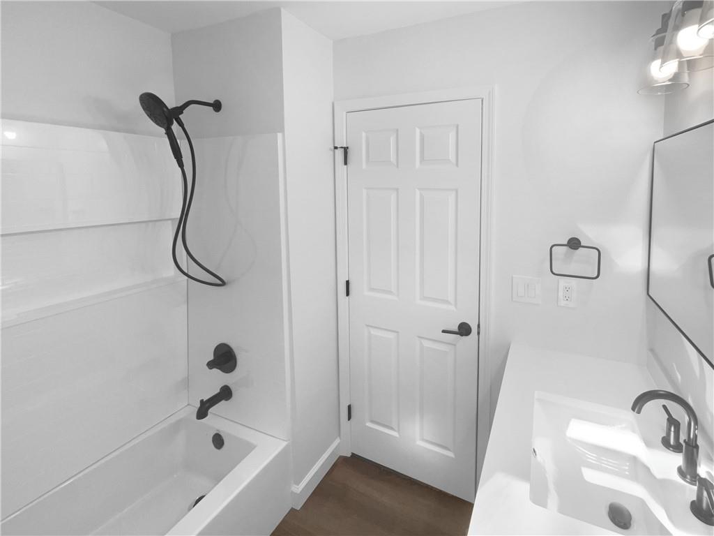 314 Jackson Street Cartersville, GA 30120 - Photo 6 of 18 a bathroom with a bath tub with a shower