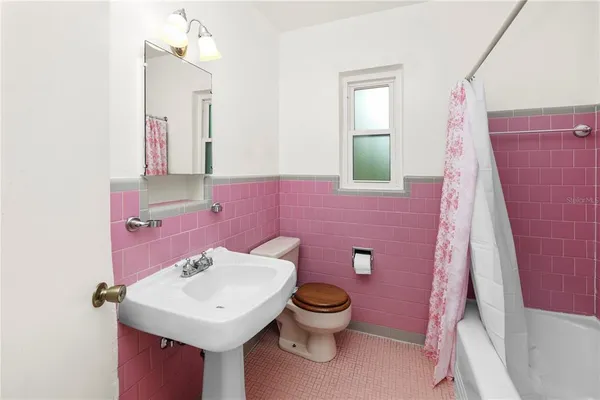a bathroom with a sink a toilet and bathtub