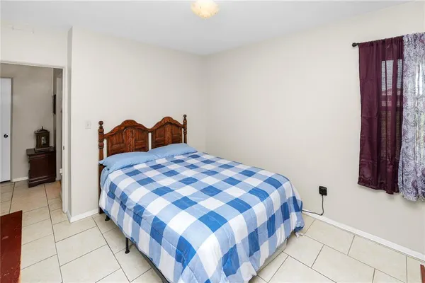 a bedroom with a bed and a mirror