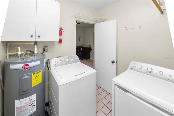 a kitchen with a refrigerator and a stove top oven