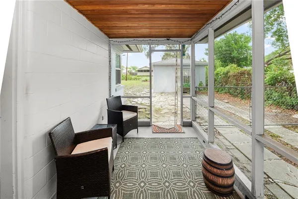 a living room with furniture and a floor to ceiling window