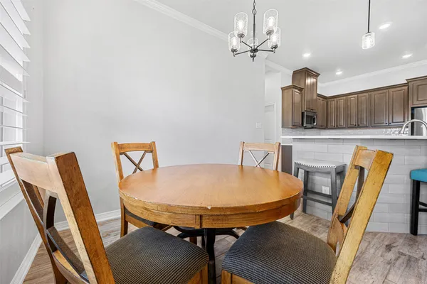 a view of a dining room with furniture and chandelier