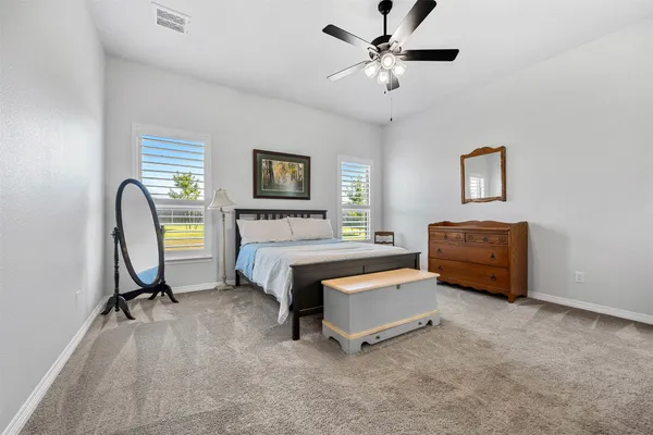 a living room with furniture and a ceiling fan