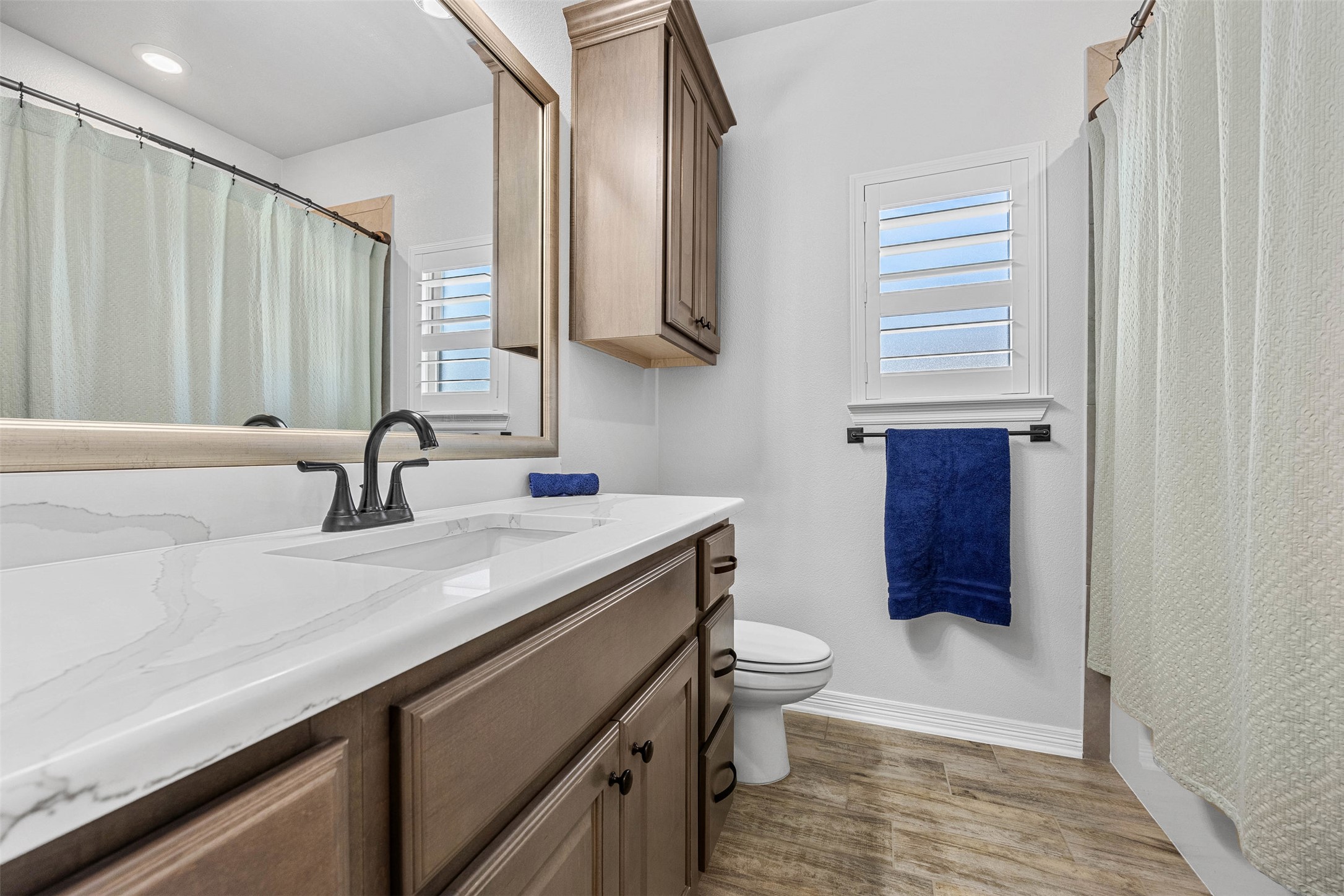 5513 Hollow Loop Salado, TX 76571 - Photo 25 of 36 a bathroom with a granite countertop sink a toilet and a mirror