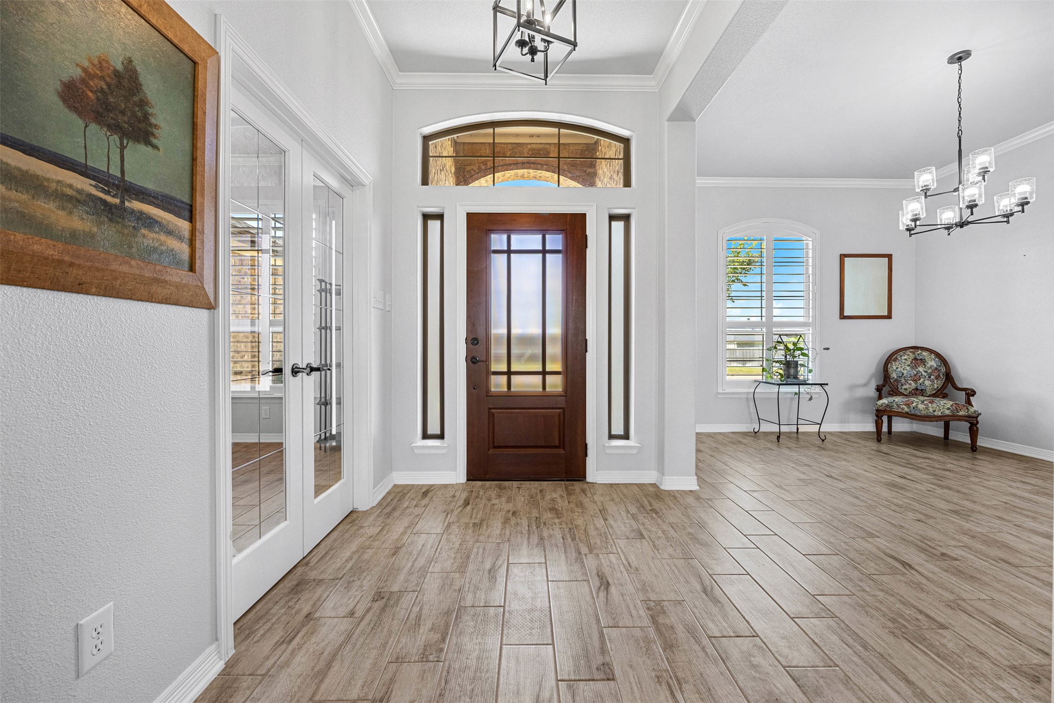 5513 Hollow Loop Salado, TX 76571 - Photo 5 of 36 a view of a hallway with wooden floor and a chandelier