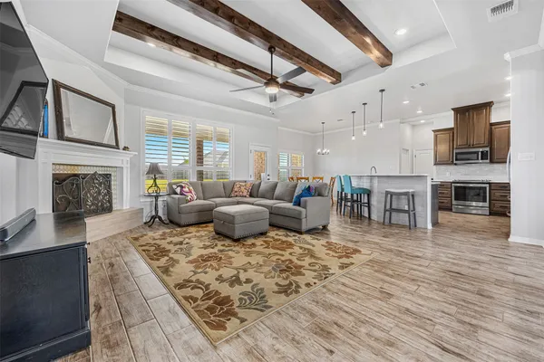 a living room with furniture a fireplace and a flat screen tv